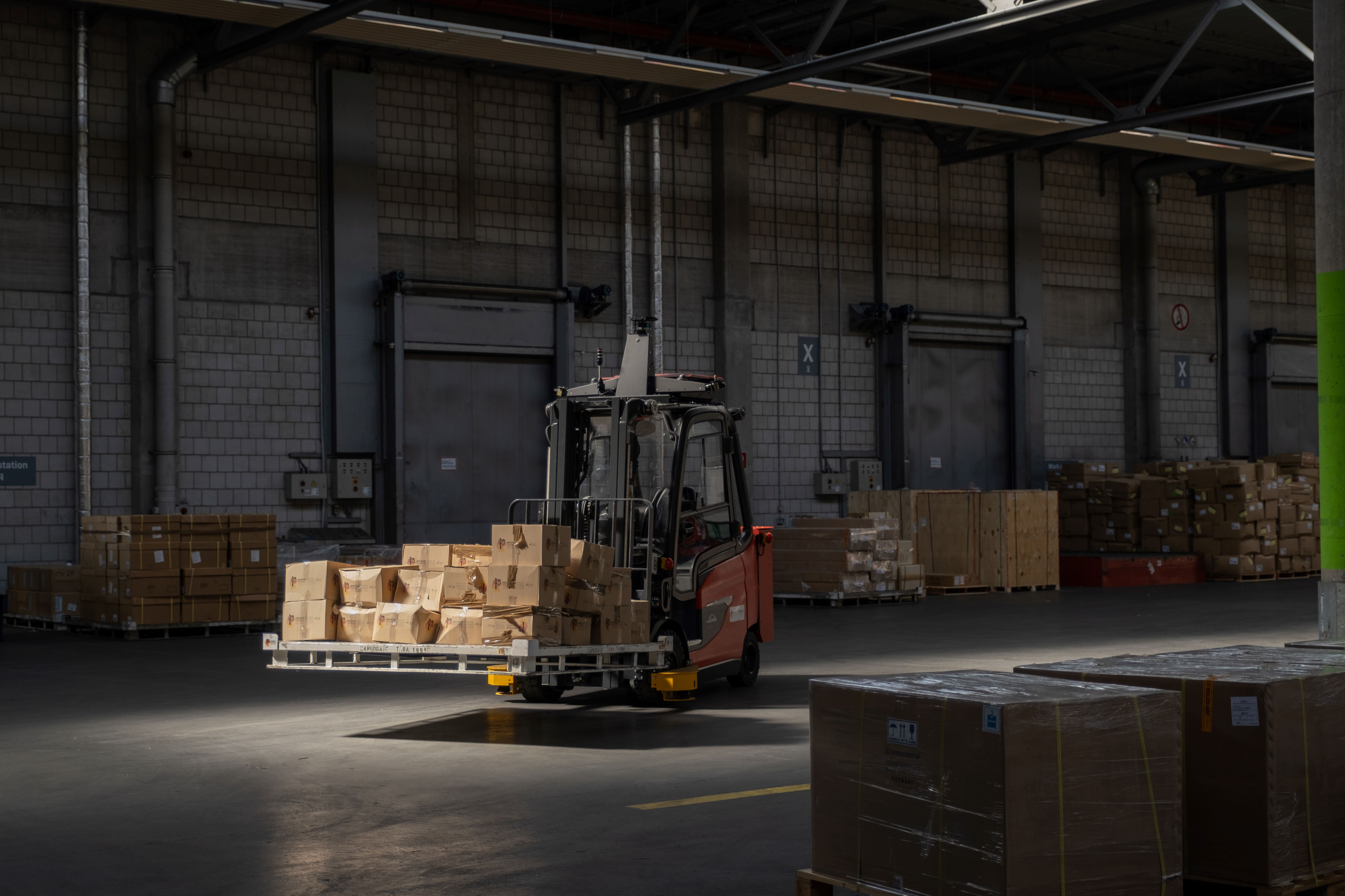 A forklift truck transports packages within a warehouse