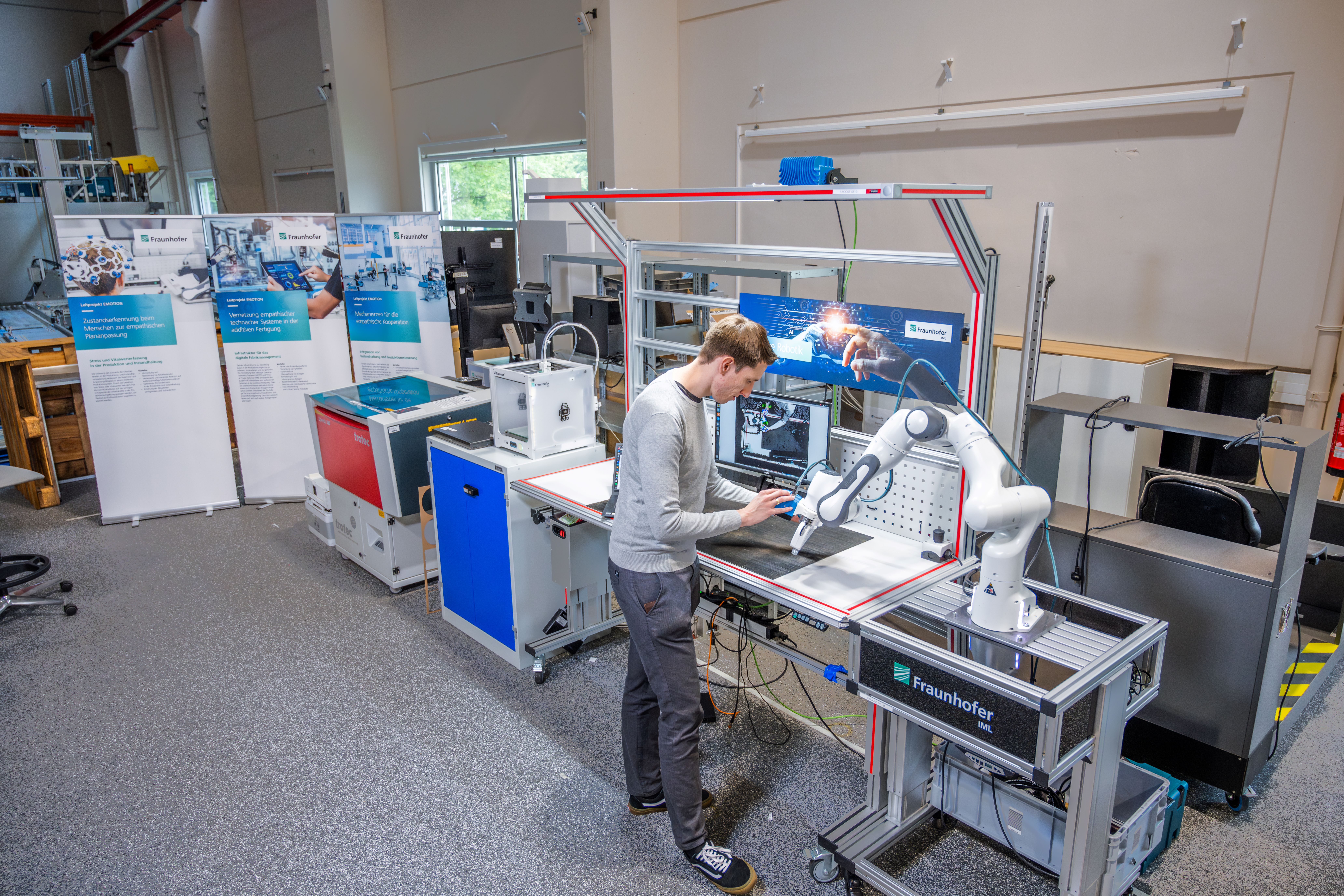 A man is working on a machine in a laboratory