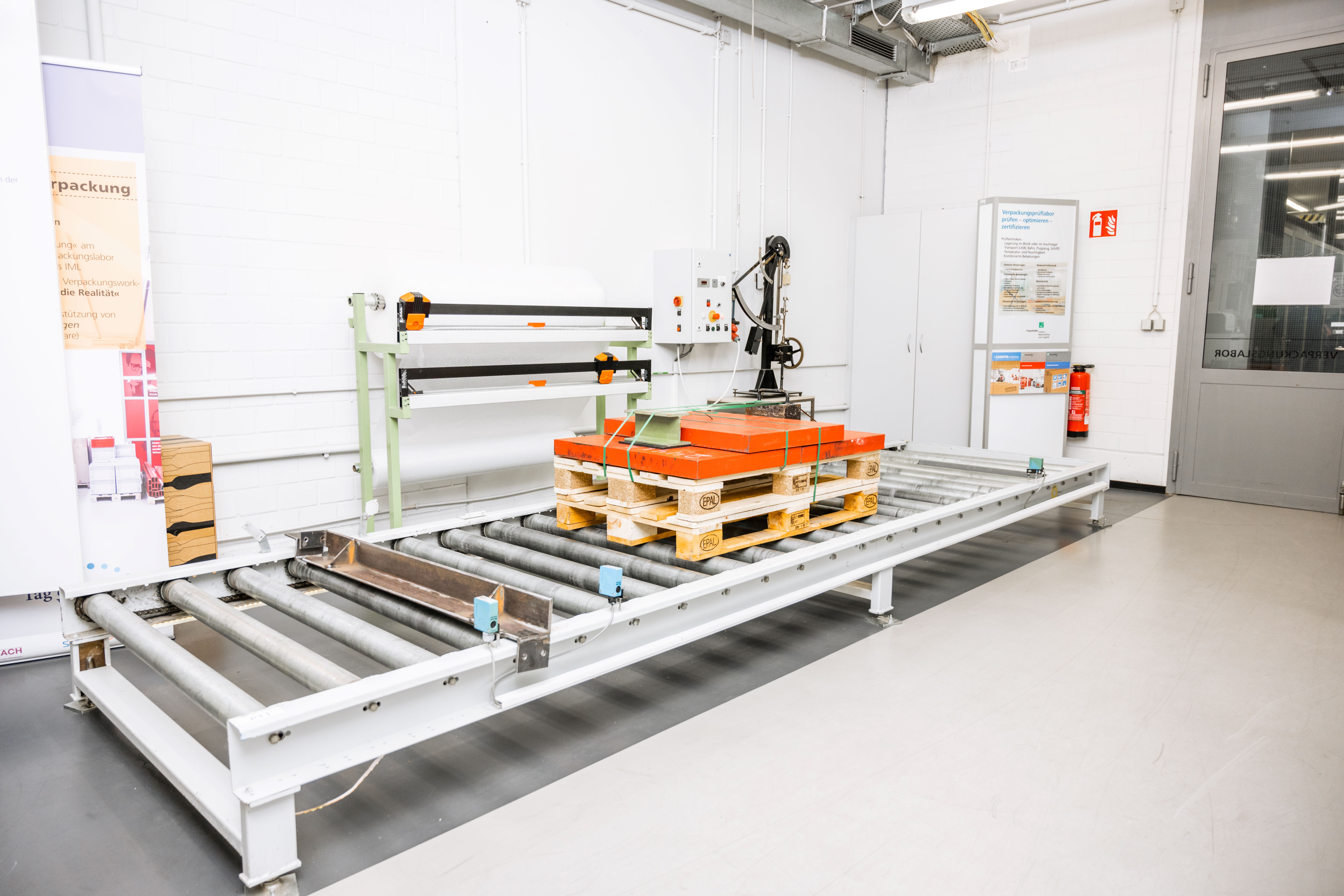 A pallet being transported on a roller track