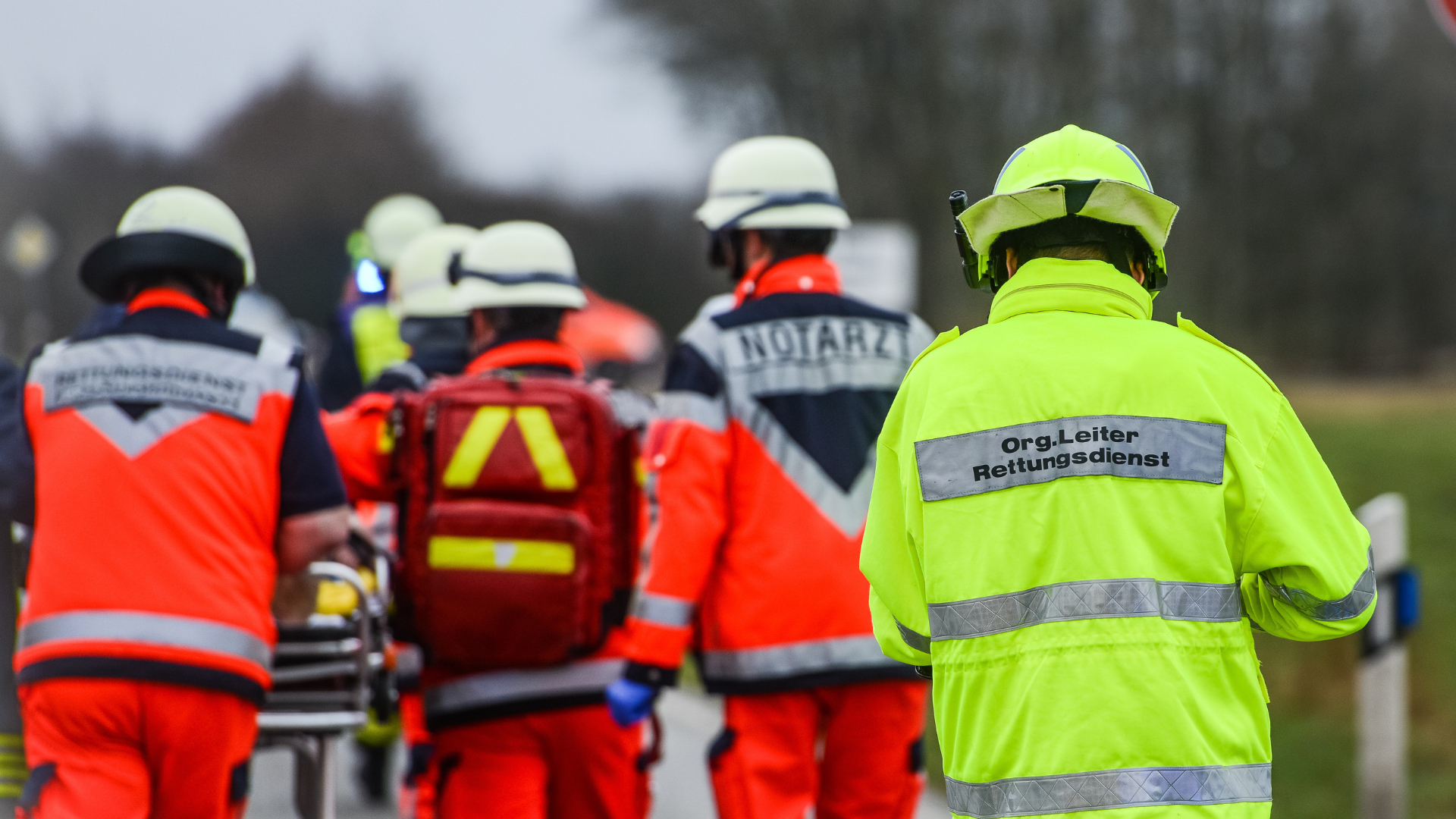 Rescue workers walking along a street.